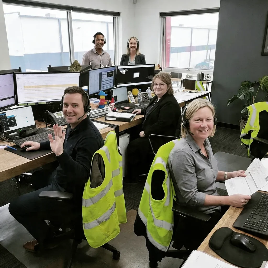 Customer service staffs in Dandenong South HQ waving to the camera